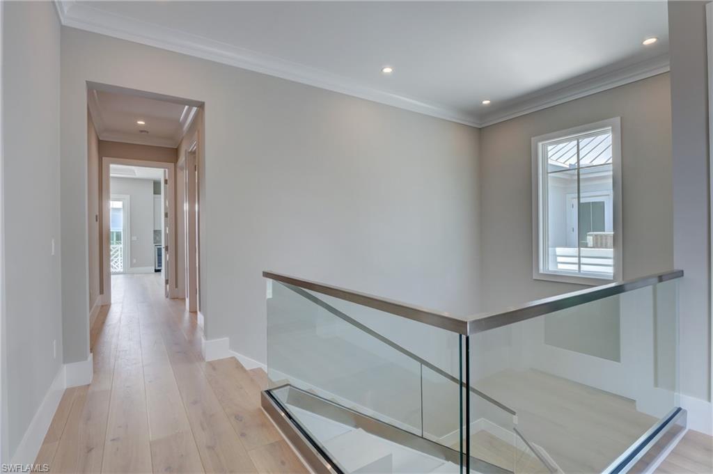 888 10th Avenue South Naples, FL 34102 - Photo 13 of 30 a view of a hallway with wooden floor and staircase