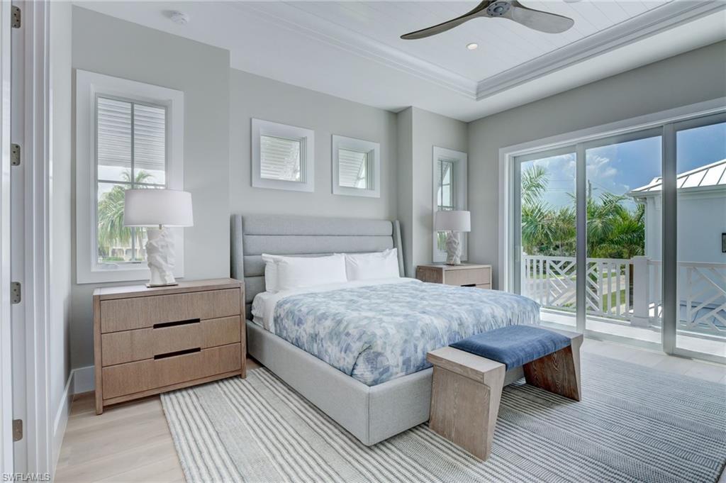 888 10th Avenue South Naples, FL 34102 - Photo 16 of 30 a bedroom with a bed and wooden floor