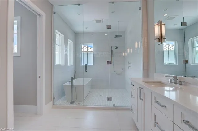 a bathroom with a double vanity sink mirror and shower