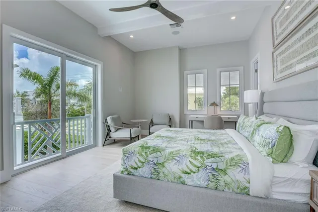 a view of a house with a yard and palm trees