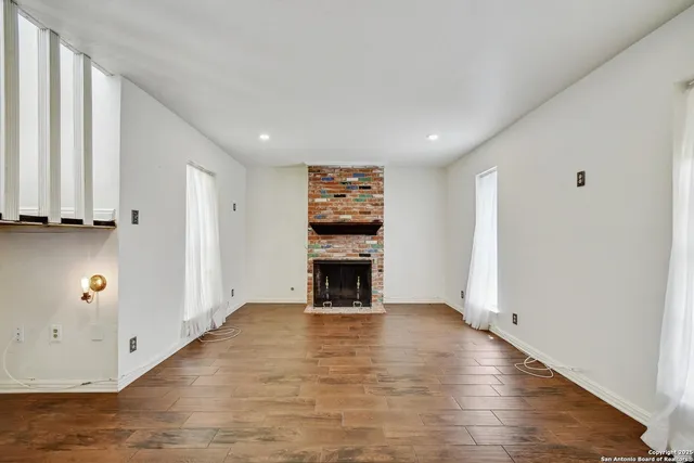 wooden floor in an empty room with a fireplace