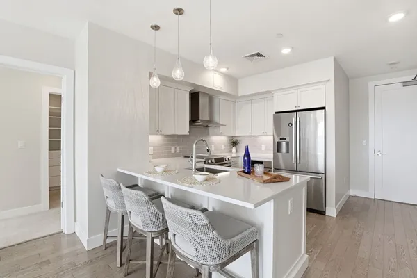 a kitchen with a refrigerator and a sink