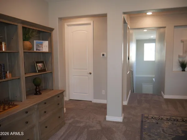 a view of bathroom with closet and wooden floor