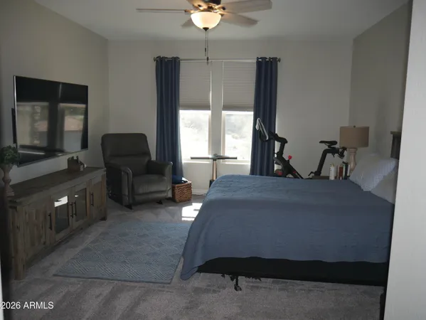 a bedroom with a bed and a chandelier