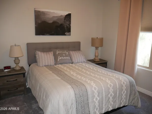 a bedroom with a bed and wall painting