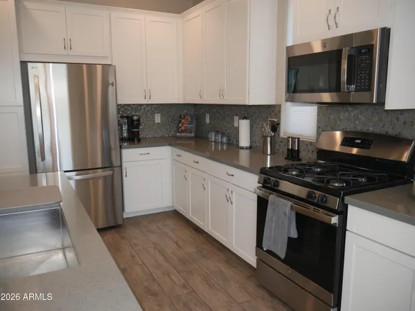 a kitchen with stainless steel appliances and wooden cabinets