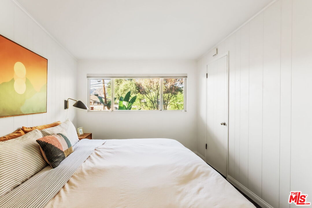 7606 Valmont Street Tujunga, CA 91042 - Photo 11 of 24 a bed room with a bed and a large window