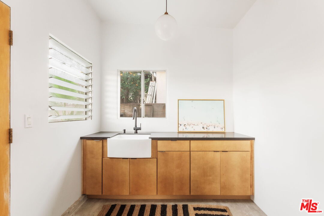 7606 Valmont Street Tujunga, CA 91042 - Photo 16 of 24 a bathroom with a sink a mirror and a window