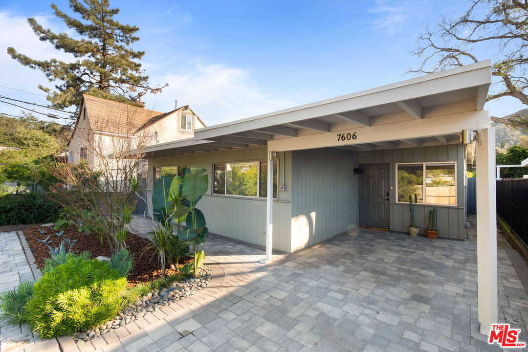 7606 Valmont Street Tujunga, CA 91042 - Photo 2 of 24 a view of a house with a backyard and potted plants