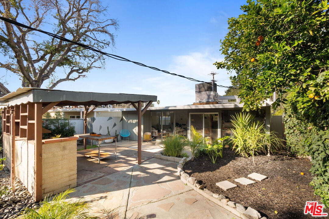 7606 Valmont Street Tujunga, CA 91042 - Photo 23 of 24 a view of a patio with table and chairs potted plants and large tree