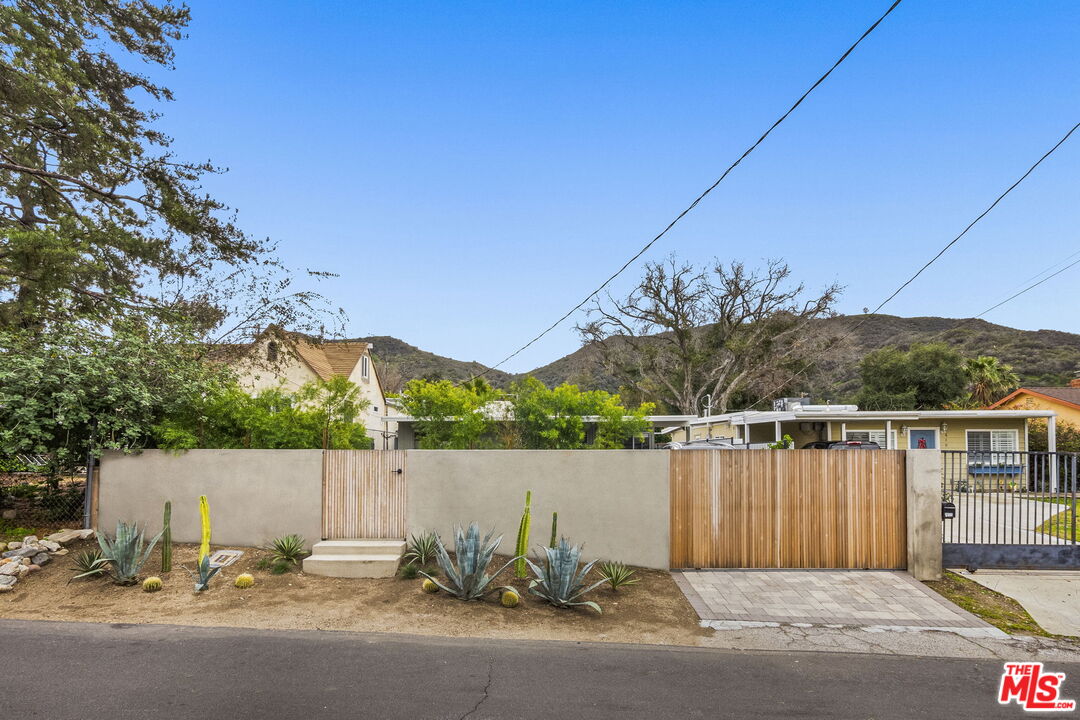 7606 Valmont Street Tujunga, CA 91042 - Photo 24 of 24 a backyard of a house with lots of green space