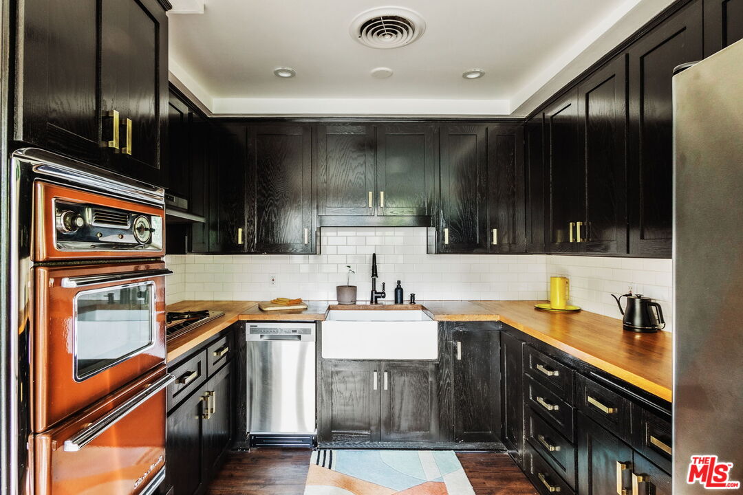 7606 Valmont Street Tujunga, CA 91042 - Photo 8 of 24 a kitchen with stainless steel appliances granite countertop a sink stove and refrigerator
