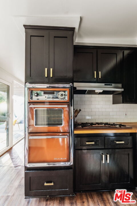 7606 Valmont Street Tujunga, CA 91042 - Photo 9 of 24 a stove top oven sitting inside of a kitchen