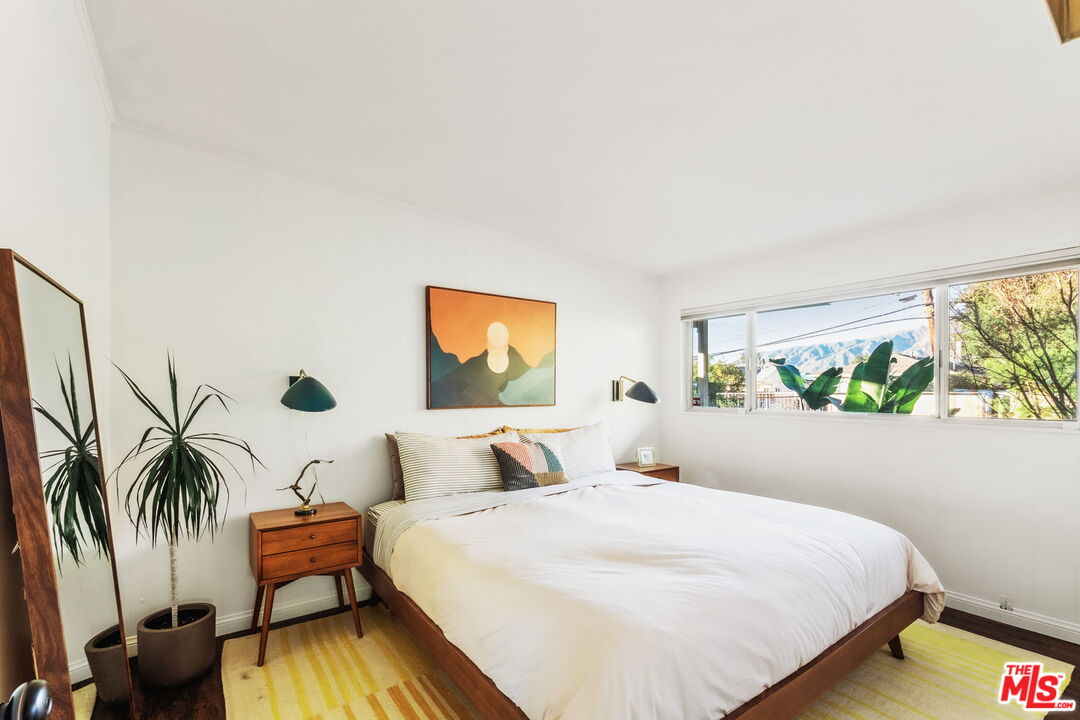 7606 Valmont Street Tujunga, CA 91042 - Photo 10 of 24 a bedroom with a bed and a painting on the wall