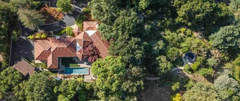 an aerial view of a house with a yard and garden