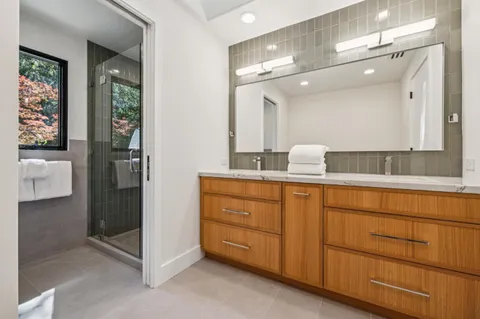 a bathroom with a granite countertop sink and a mirror