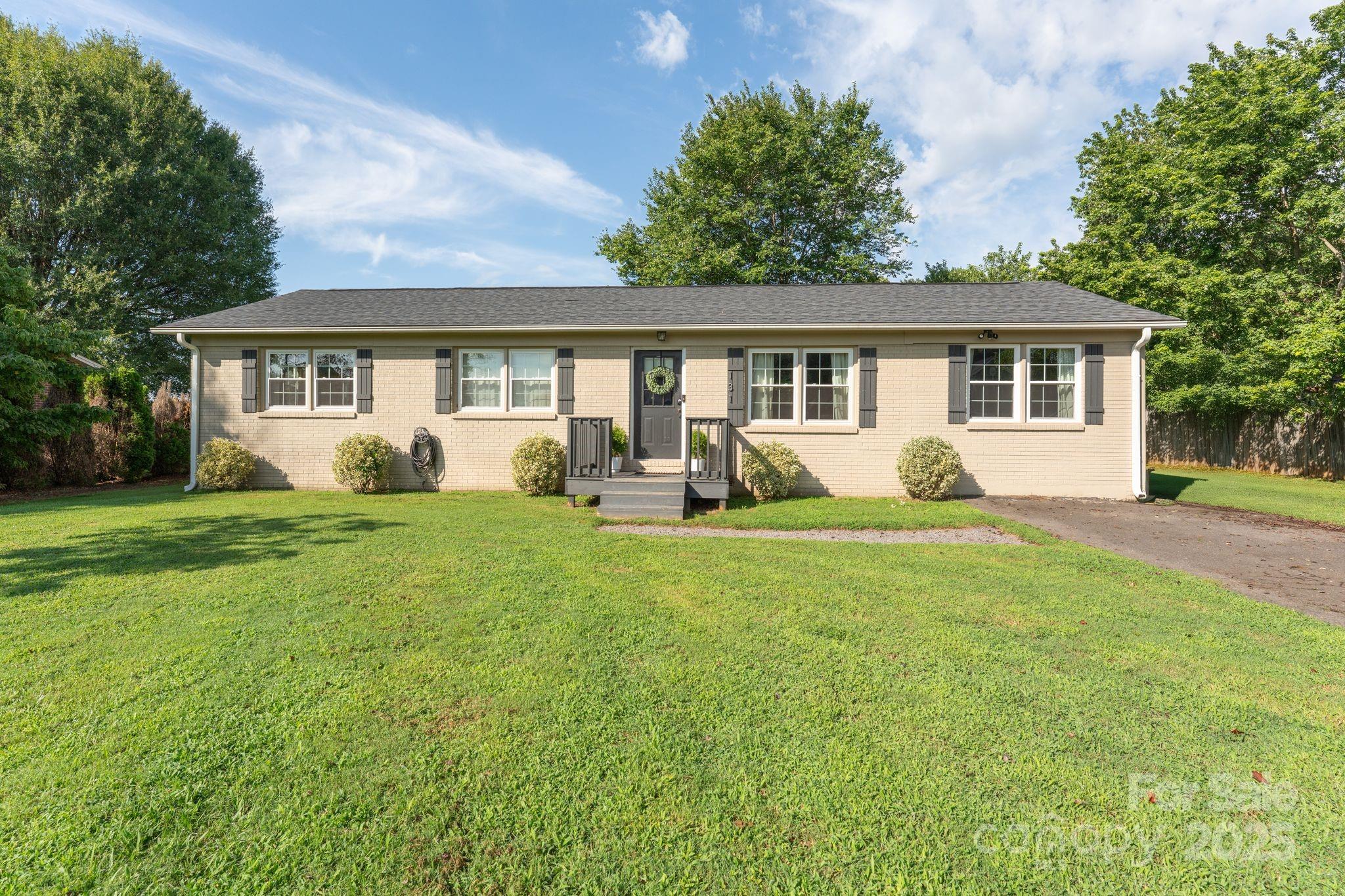 131 Sheffield Road Mocksville, NC 27028 - Photo 1 of 21 a view of a house with backyard sitting area and garden