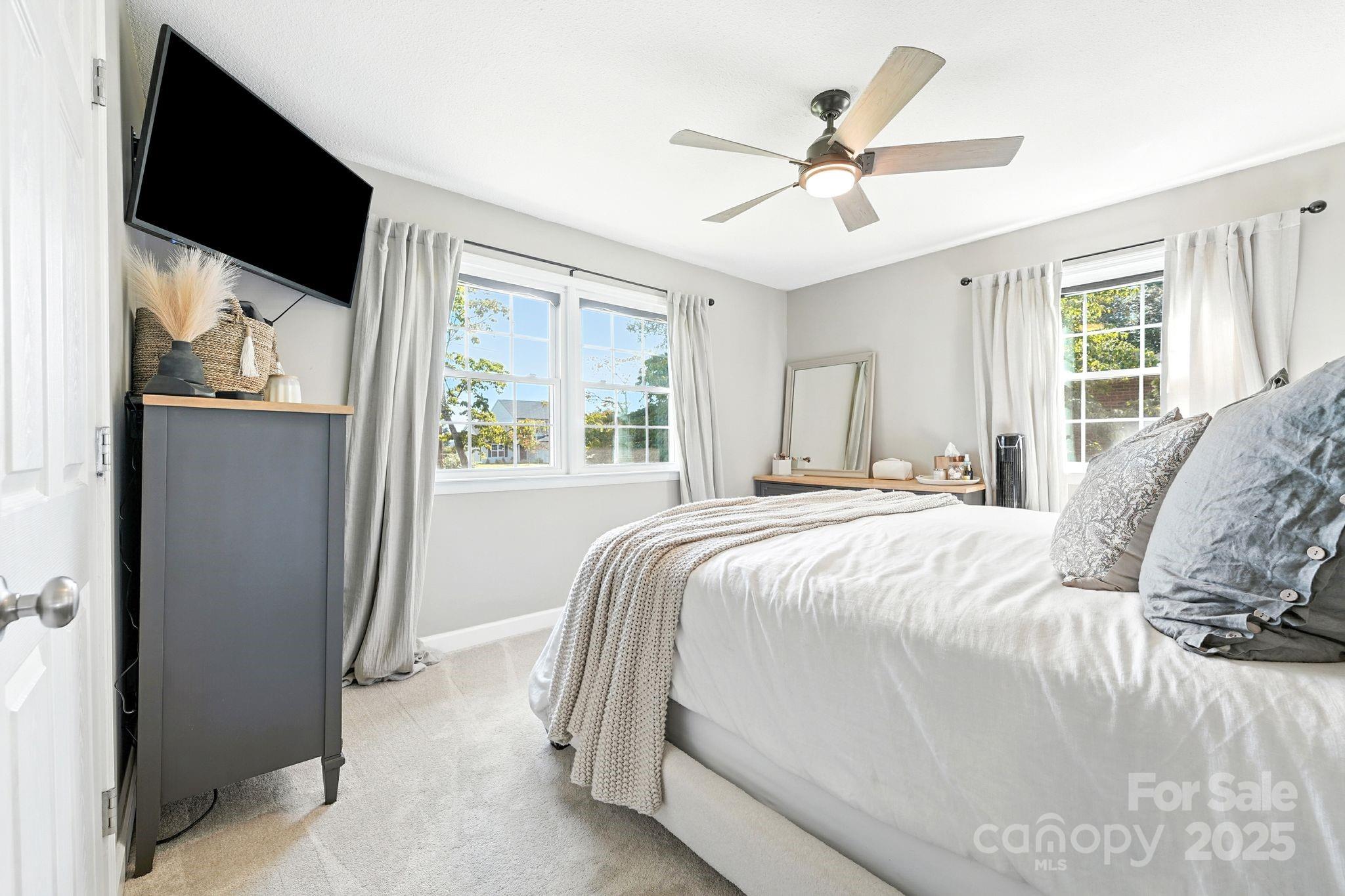 131 Sheffield Road Mocksville, NC 27028 - Photo 15 of 21 a bedroom with a bed and a flat screen tv