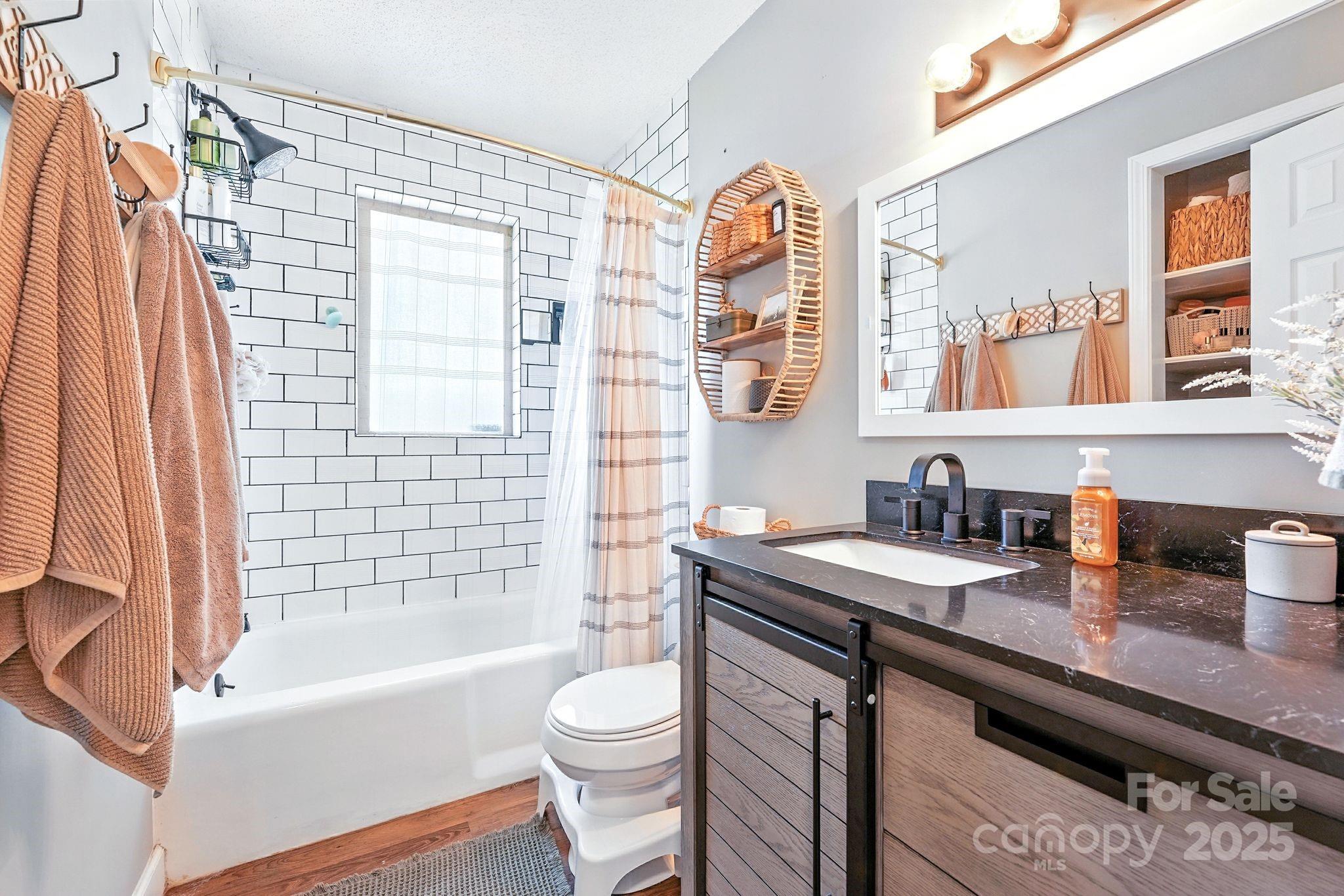 131 Sheffield Road Mocksville, NC 27028 - Photo 17 of 21 a bathroom with a granite countertop bathtub sink vanity mirror and toilet