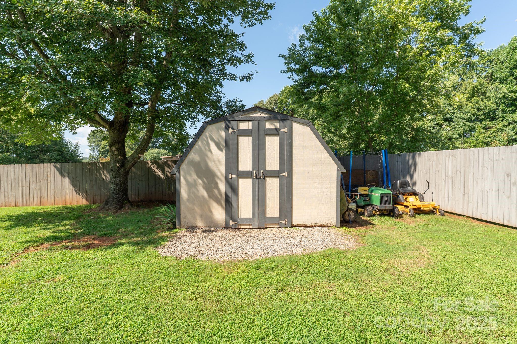 131 Sheffield Road Mocksville, NC 27028 - Photo 20 of 21 a view of backyard with small cabin and wooden fence