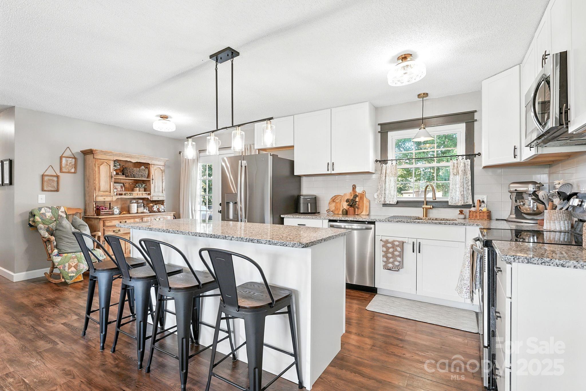131 Sheffield Road Mocksville, NC 27028 - Photo 8 of 21 a kitchen with appliances a sink a counter top space and a center island