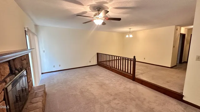 a view of a livingroom with a ceiling fan and window