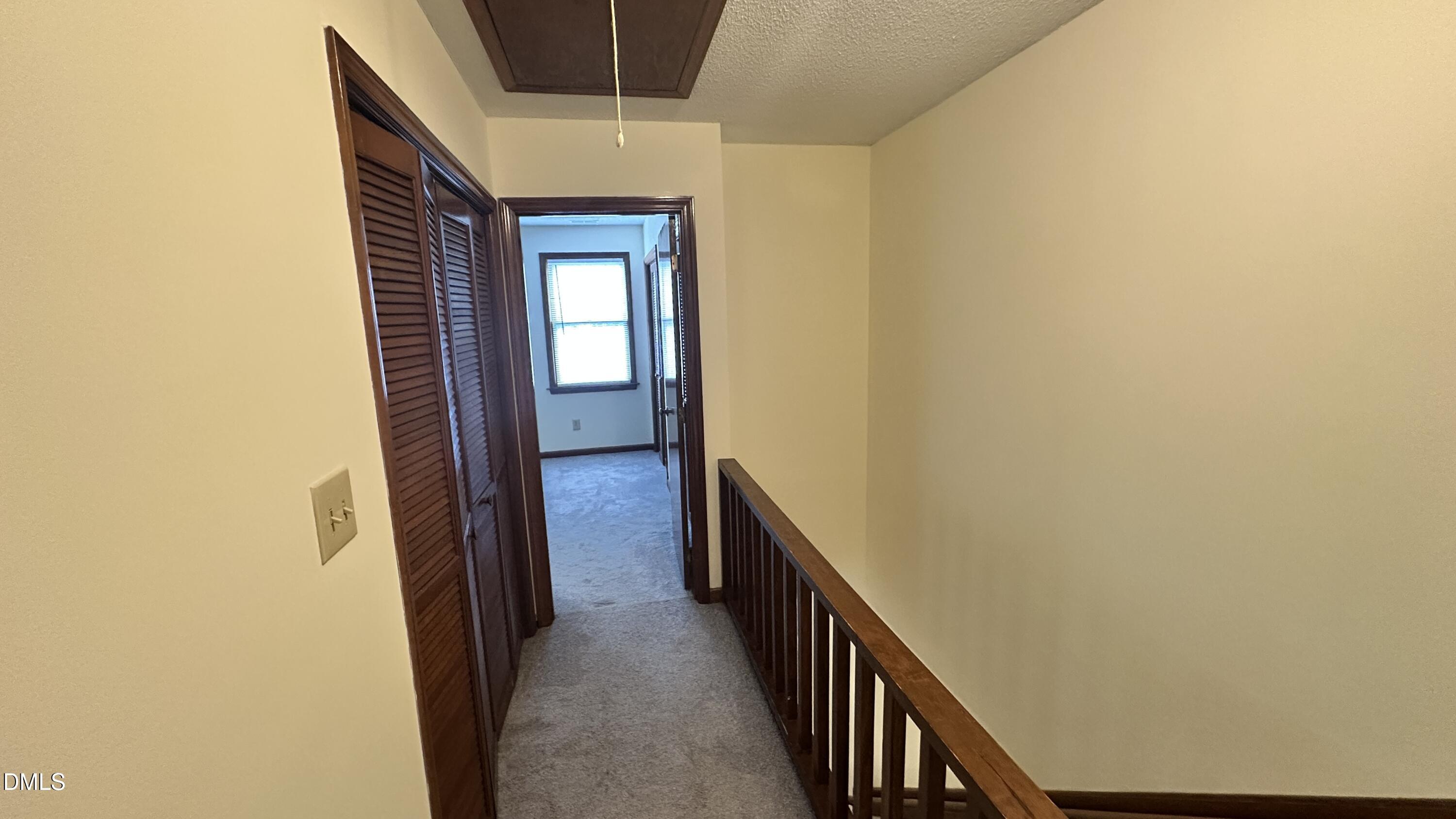 4705 Fargo Court, Unit B Raleigh, NC 27612 - Photo 6 of 9 a view of a hallway with wooden floor and staircase