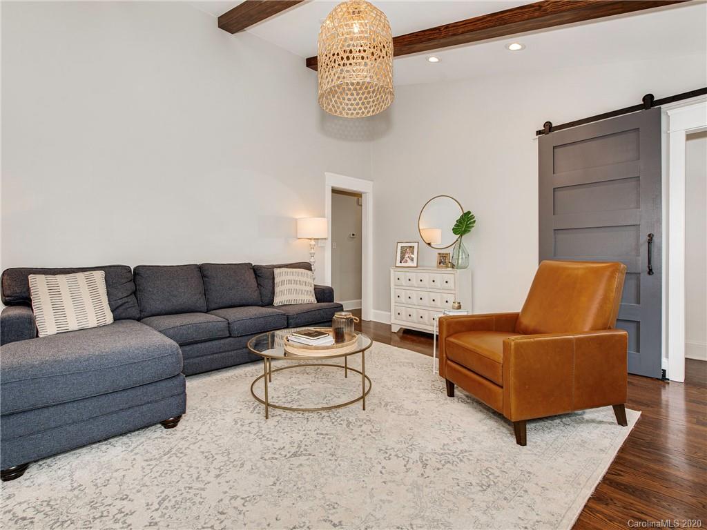 722 Trail Ridge Road Matthews, NC 28105 - Photo 14 of 32 a living room with furniture a rug and a chandelier