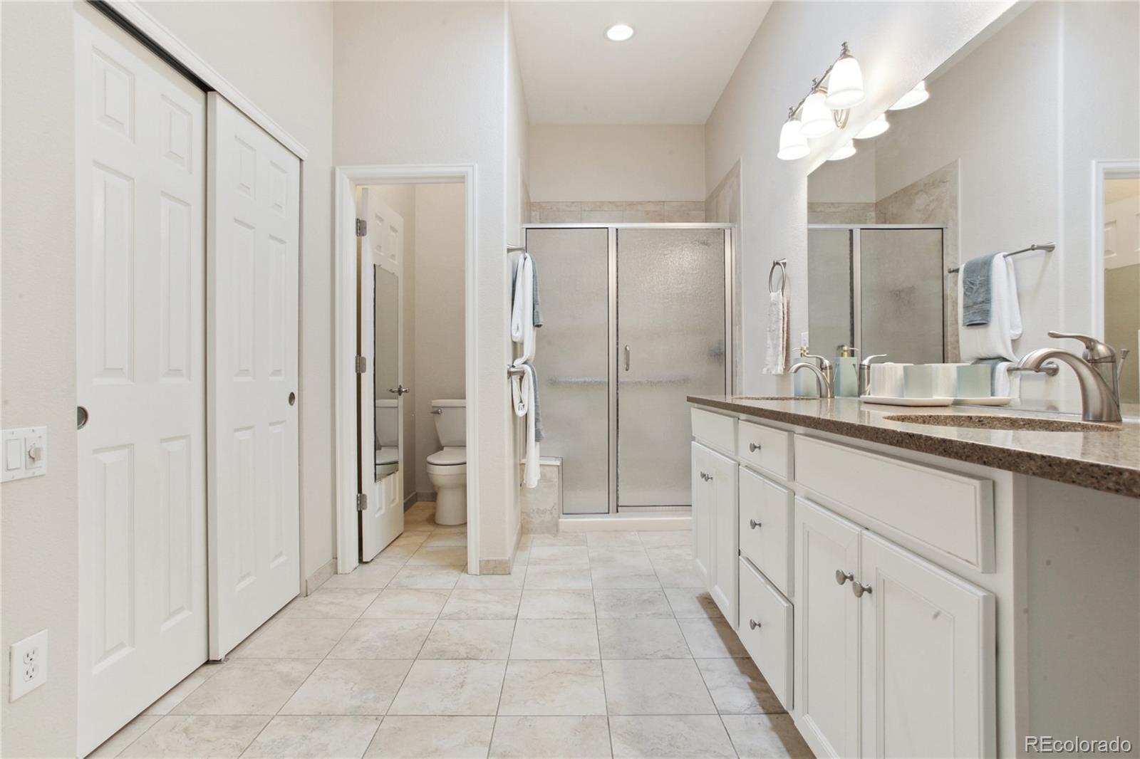 3626 Pointer Way Highlands Ranch, CO 80126 - Photo 12 of 33 a bathroom with a double vanity sink mirror and shower