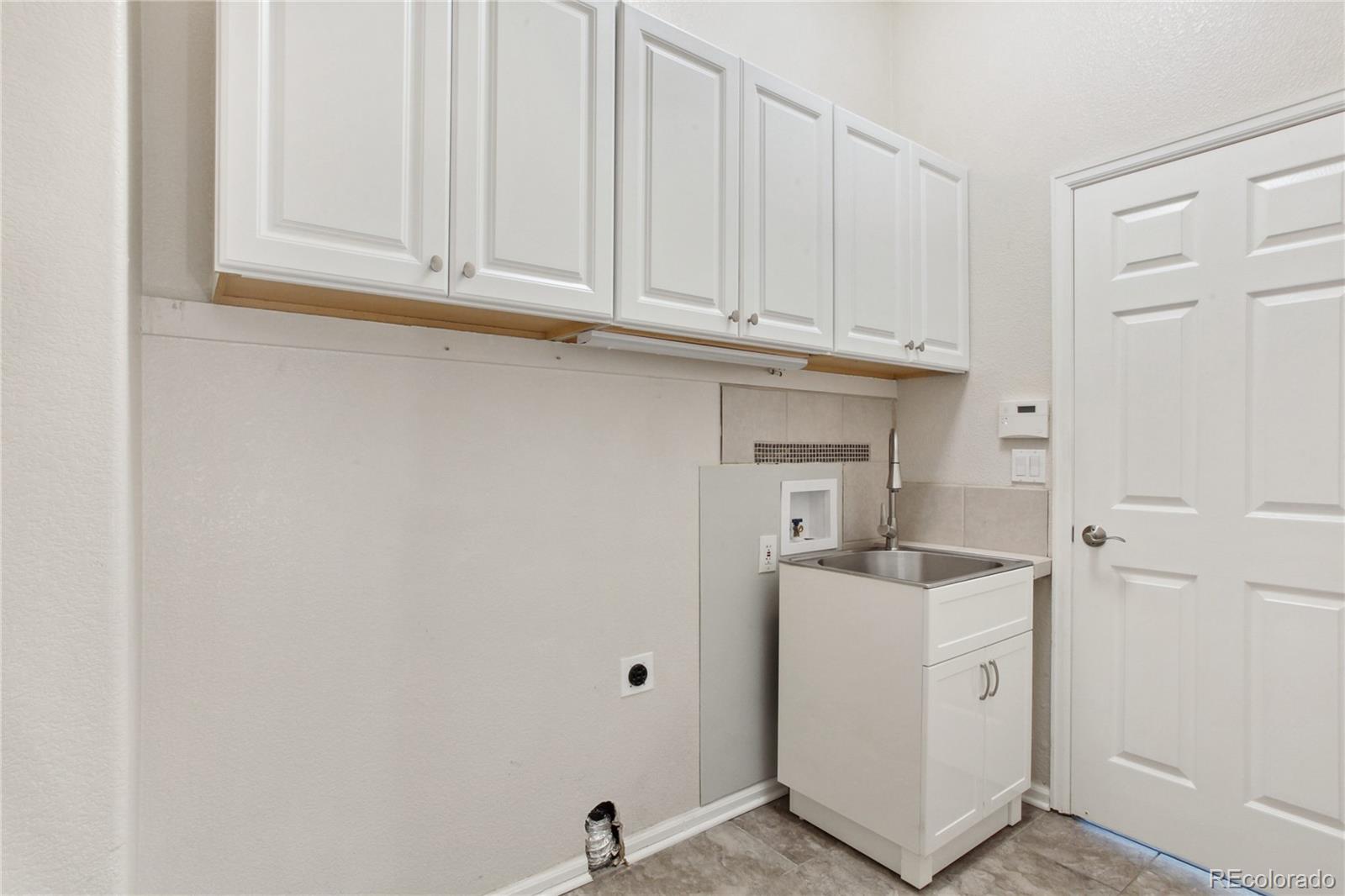 3626 Pointer Way Highlands Ranch, CO 80126 - Photo 17 of 33 a view of cabinets and utility room with washer and dryer
