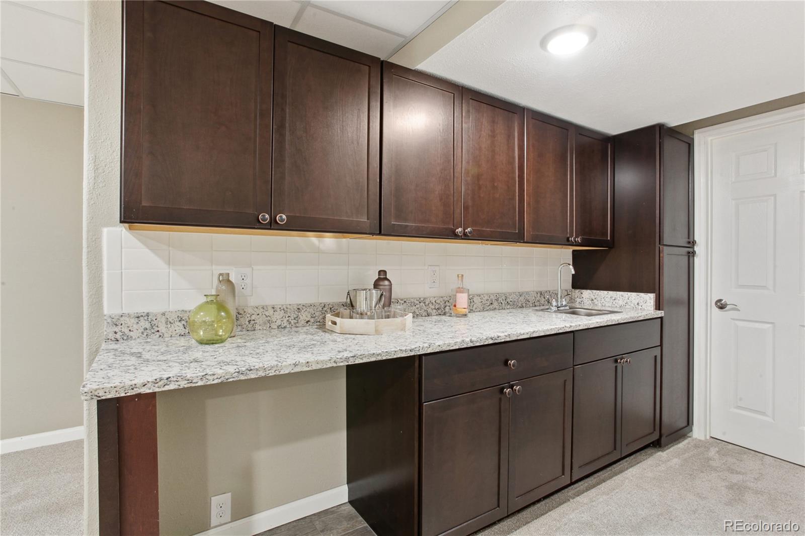 3626 Pointer Way Highlands Ranch, CO 80126 - Photo 19 of 33 a bathroom with a granite countertop sink and a mirror