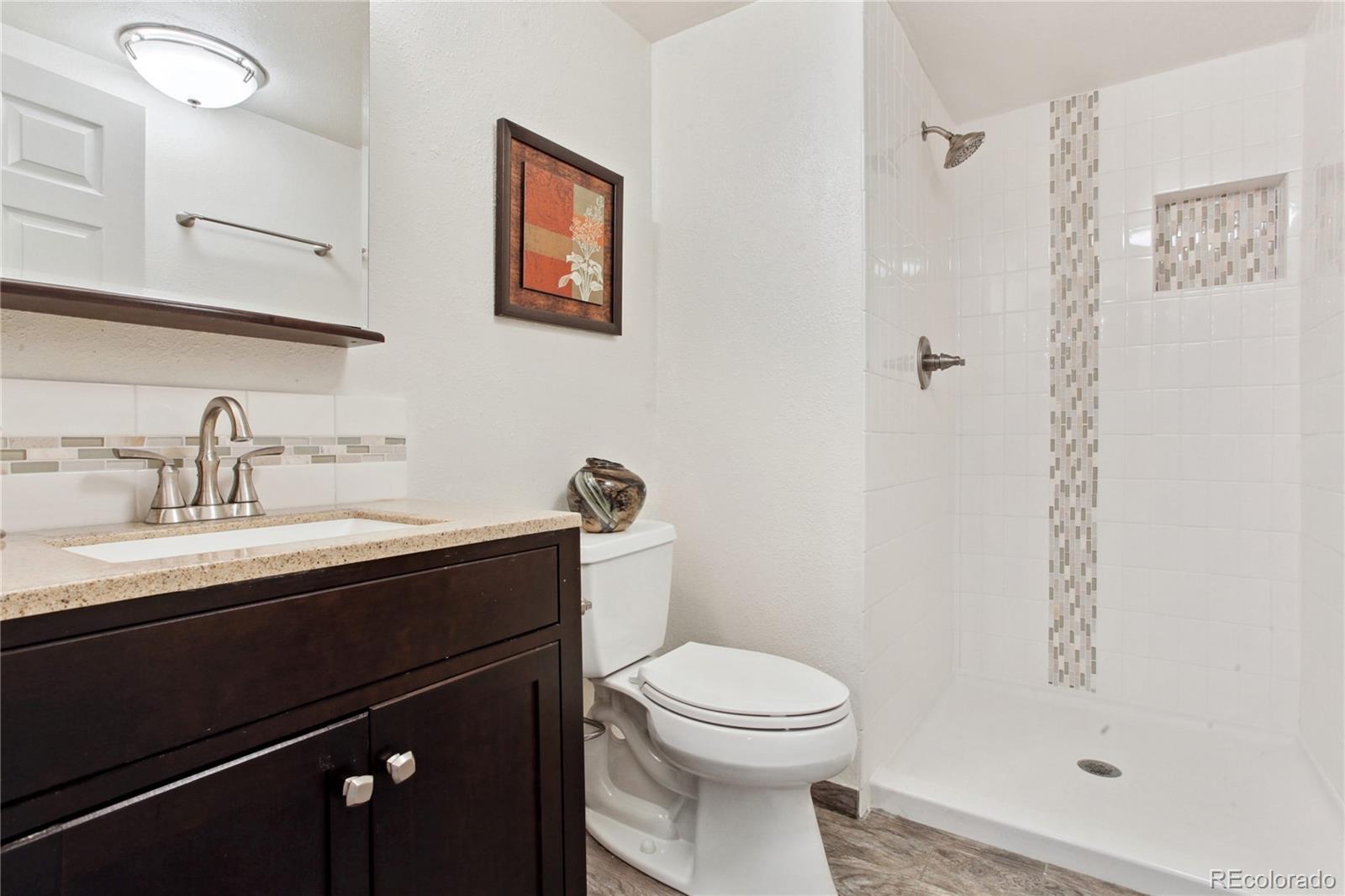 3626 Pointer Way Highlands Ranch, CO 80126 - Photo 21 of 33 a bathroom with a sink a toilet and shower