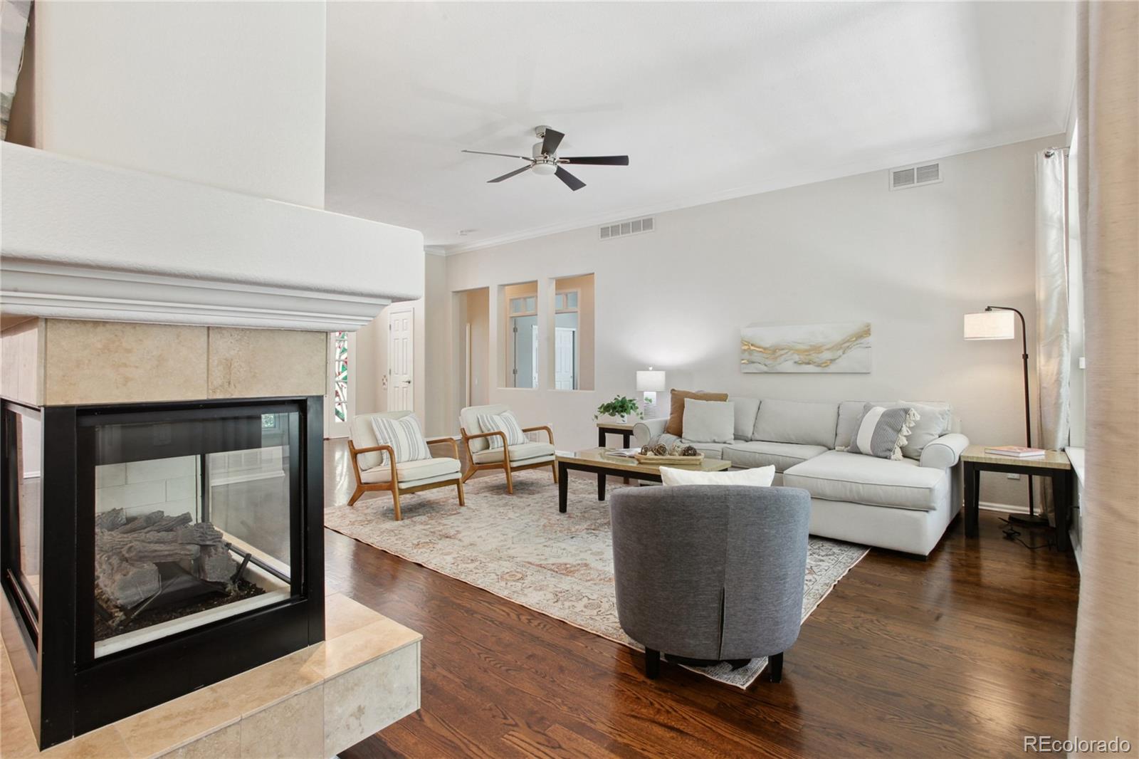 3626 Pointer Way Highlands Ranch, CO 80126 - Photo 5 of 33 a living room with furniture a fireplace and wooden floor