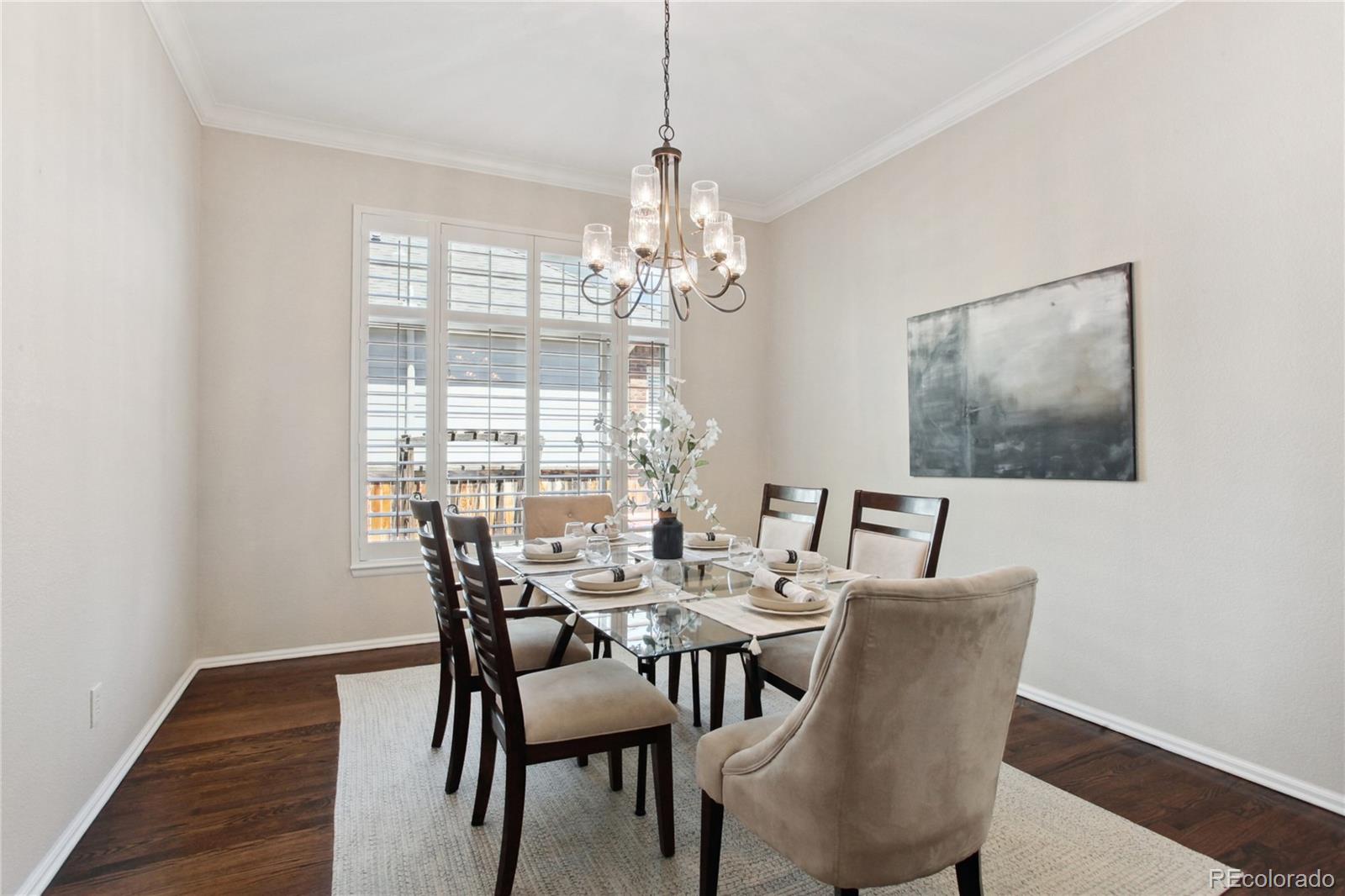 3626 Pointer Way Highlands Ranch, CO 80126 - Photo 6 of 33 a view of a dining room with furniture wooden floor and a chandelier