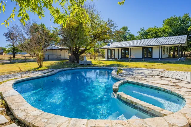 a view of an house with backyard and balcony
