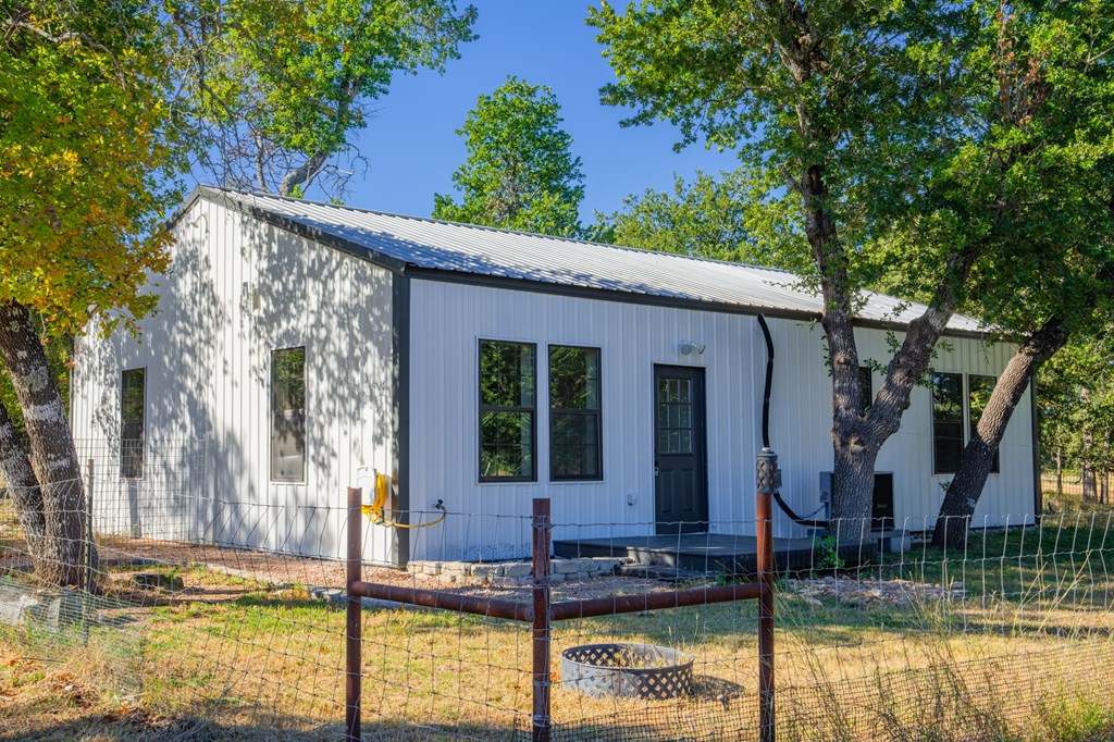 28 Ruger Road Fredericksburg, TX 78624 - Photo 22 of 43 a view of house with swimming pool and a tree