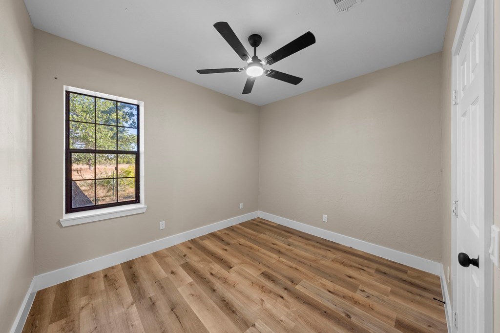 28 Ruger Road Fredericksburg, TX 78624 - Photo 27 of 43 wooden floor in an empty room with a window