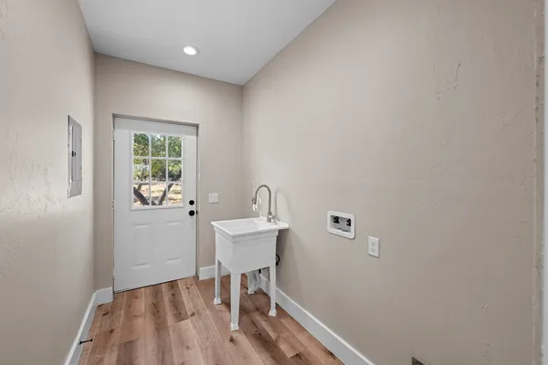 a kitchen with a refrigerator a sink and dishwasher with wooden floor