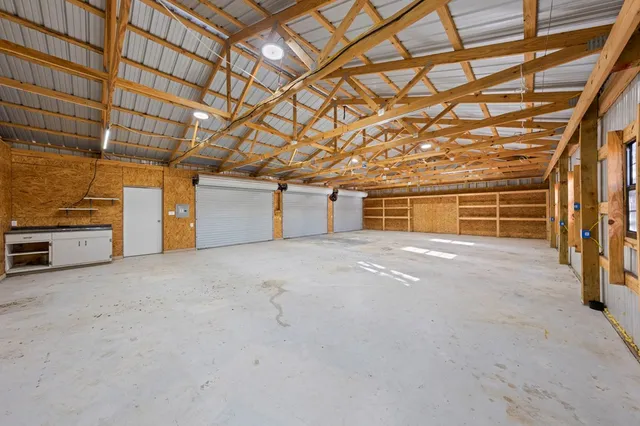 a view of backyard with swimming pool and trees in the background