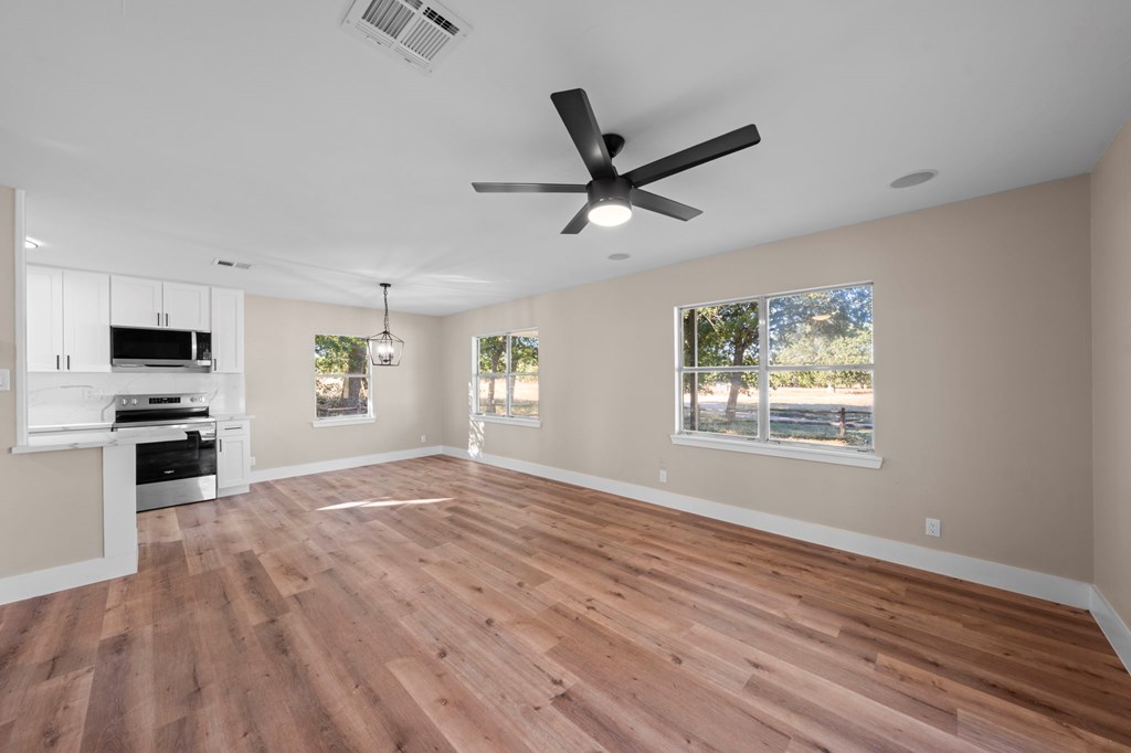 28 Ruger Road Fredericksburg, TX 78624 - Photo 7 of 43 a view of an empty room with a window and kitchen view
