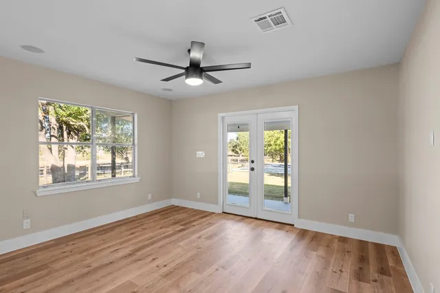 wooden floor in an empty room with a window