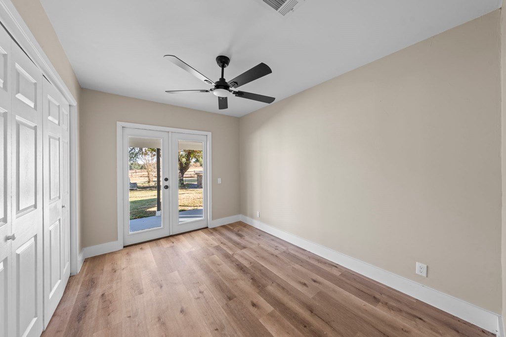 28 Ruger Road Fredericksburg, TX 78624 - Photo 10 of 43 wooden floor in an empty room with a window