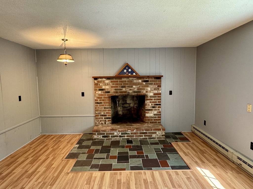 92 Clesson Brook Road Buckland, MA 01339 - Photo 16 of 38 a living room with a fireplace and a rug
