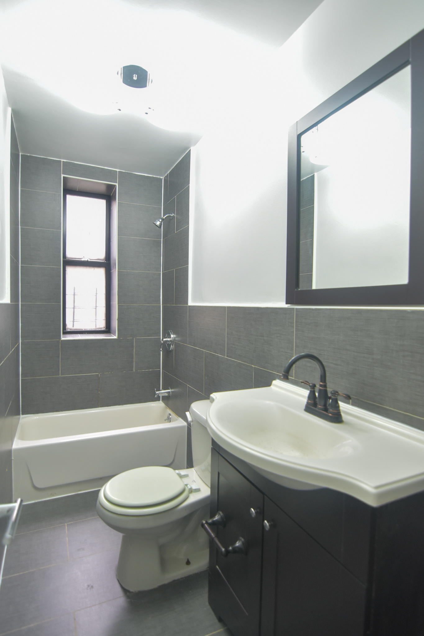 304 West 151st Street, Unit 12A Manhattan, NY 10039 - Photo 1 of 6 a bathroom with a sink toilet and shower