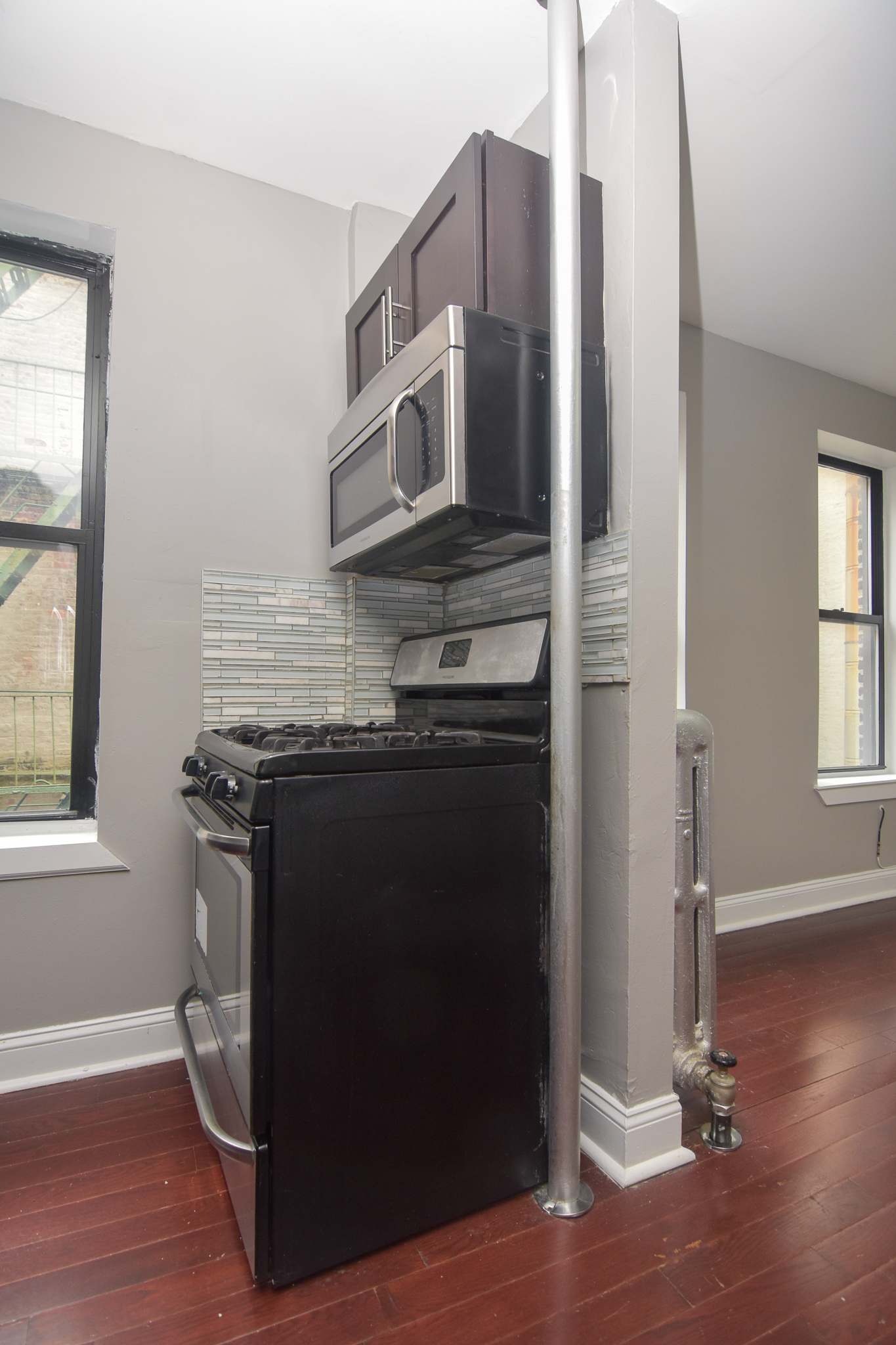 304 West 151st Street, Unit 12A Manhattan, NY 10039 - Photo 3 of 6 a kitchen with stainless steel appliances granite countertop a stove and a refrigerator