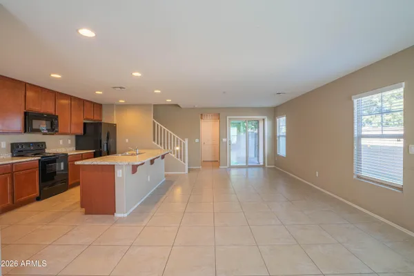 a large kitchen with stainless steel appliances granite countertop a large counter top and a stove