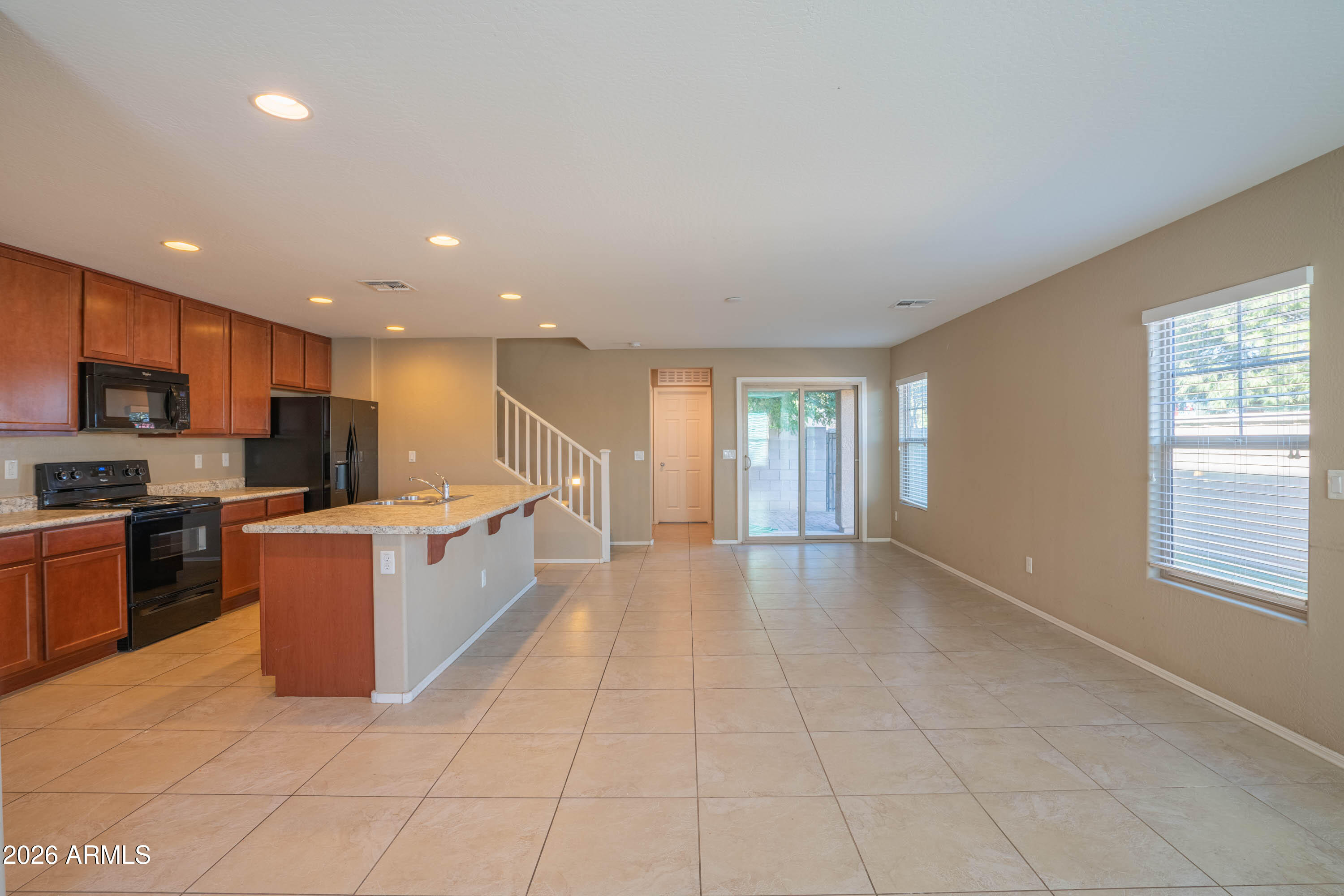 533 North Ranger Trail Gilbert, AZ 85234 - Photo 5 of 35 a large kitchen with stainless steel appliances granite countertop a large counter top and a stove