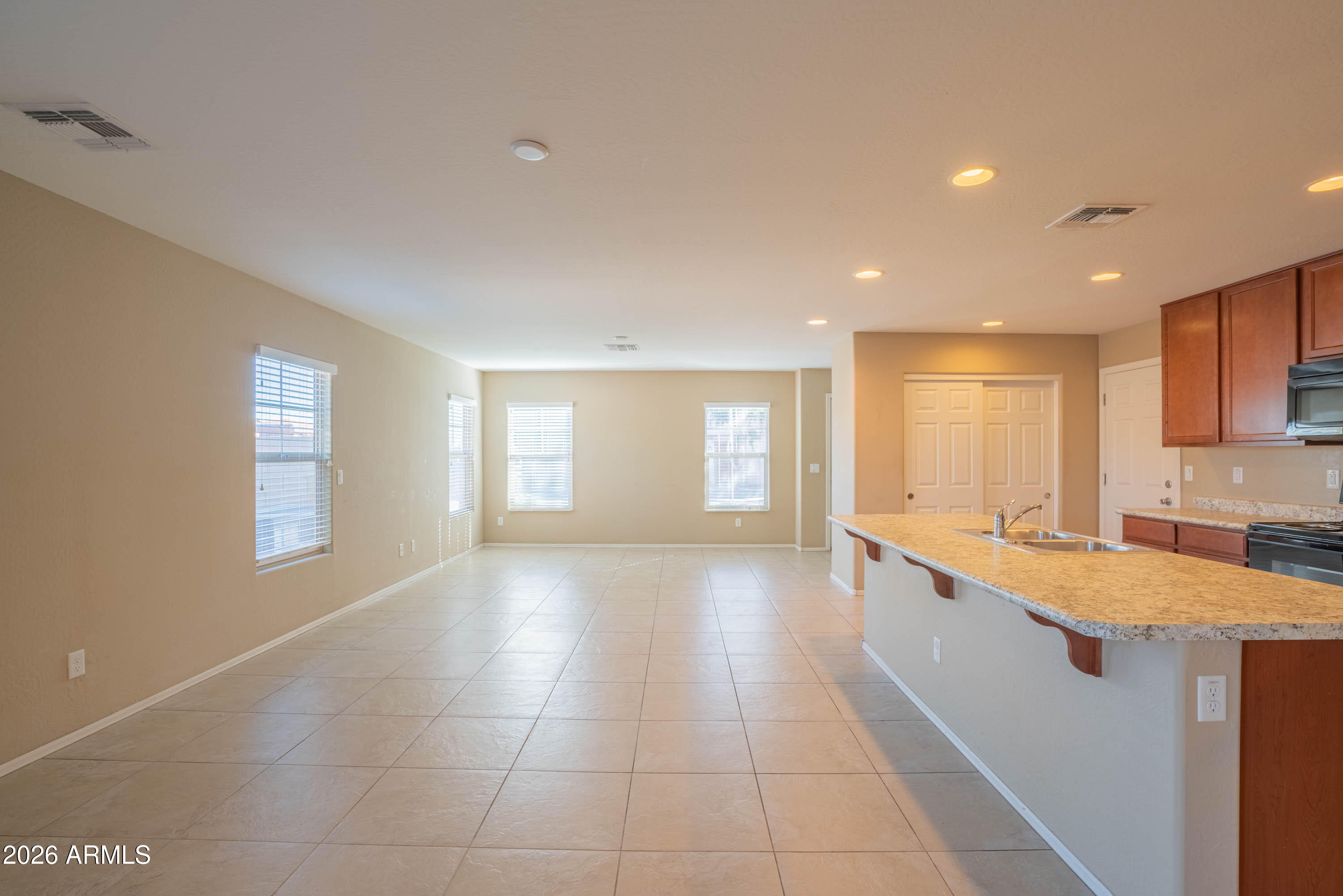 533 North Ranger Trail Gilbert, AZ 85234 - Photo 7 of 35 a large kitchen with stainless steel appliances granite countertop a sink and dishwasher with a granite countertops