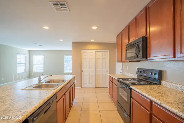 a kitchen with a sink stove and cabinets