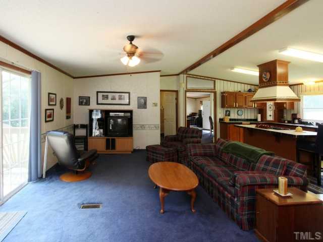 4902 West Ten Road Efland, NC 27243 - Photo 12 of 25 a living room with furniture and a chandelier